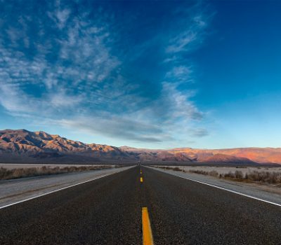 Landscape with a highway and mountains. Death Valley National Park.